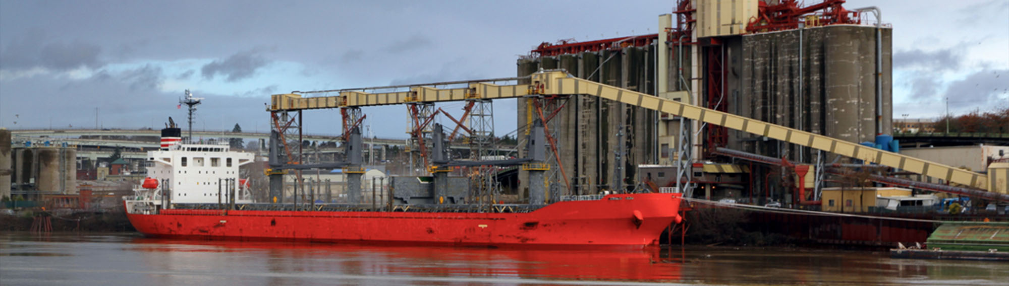 Transmarine worker with with binoculars looking out from a ship.