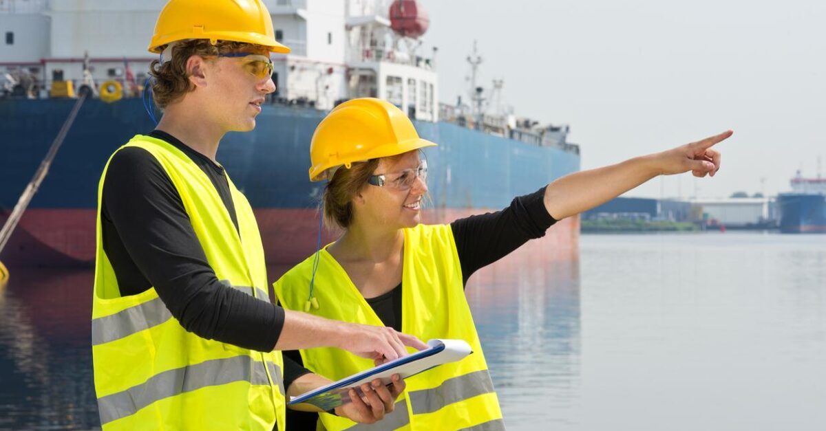 Ship workers in hardhats and reflective vests