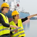 Ship workers in hardhats and reflective vests